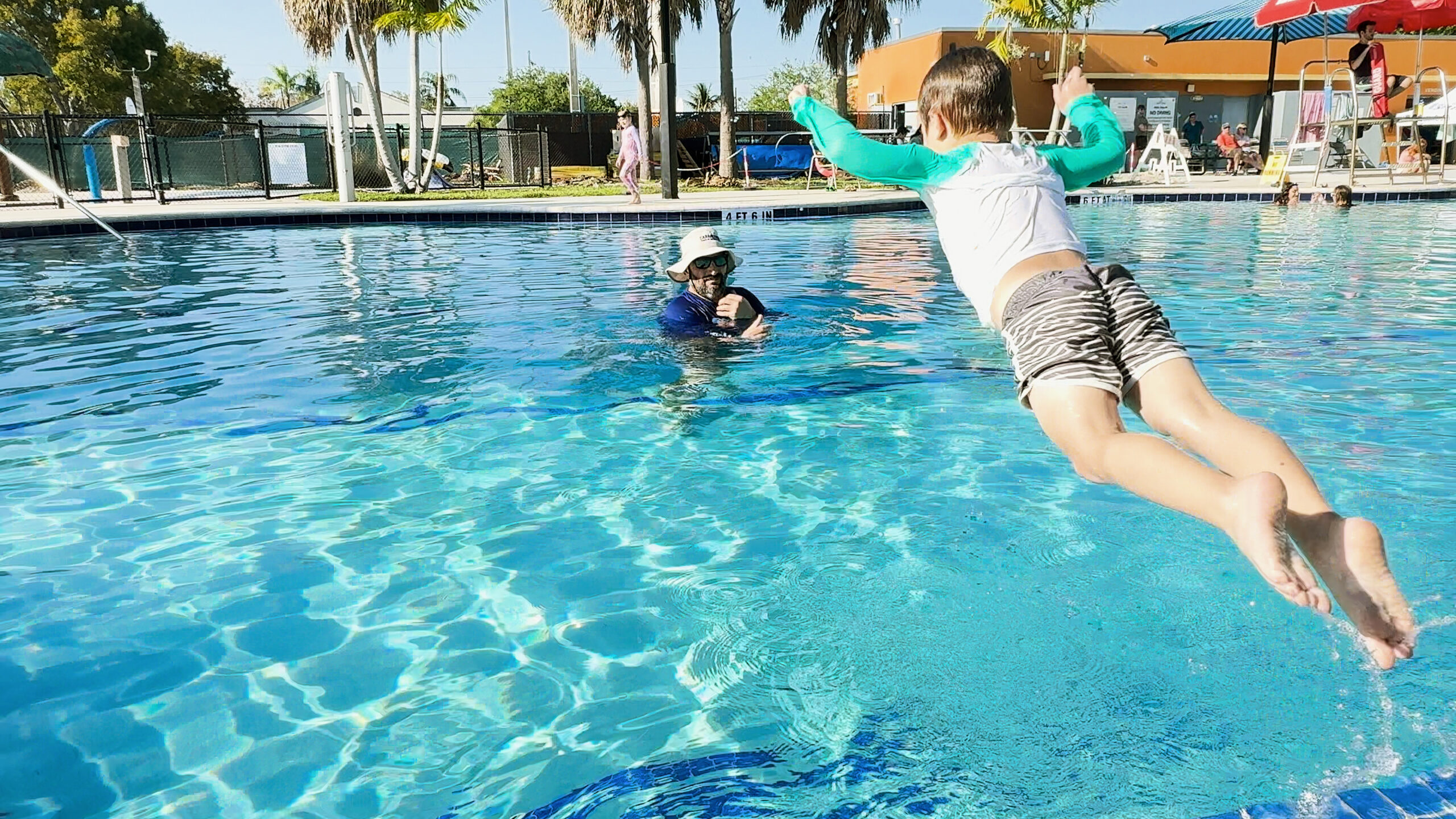 iSwim instructor teaching a child to swim in South Miami